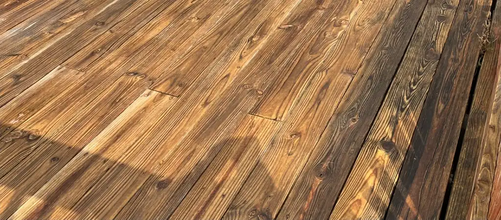 The same deck boards washed back to golden wood