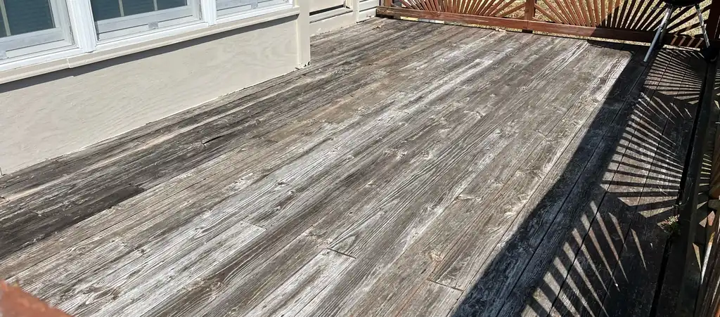Weathered grey deck boards before washing