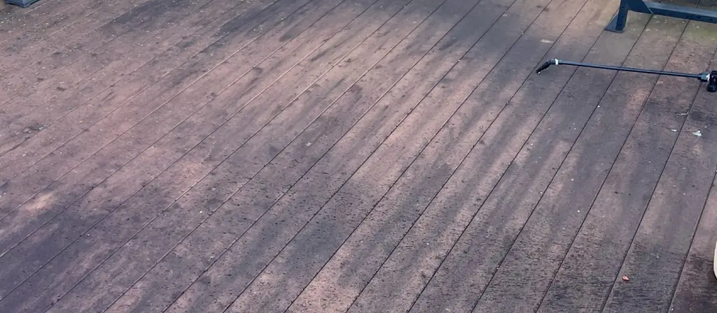 Red composite deck dulled grey before washing